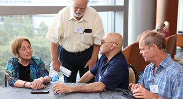 Three NFB members chat together at convention.